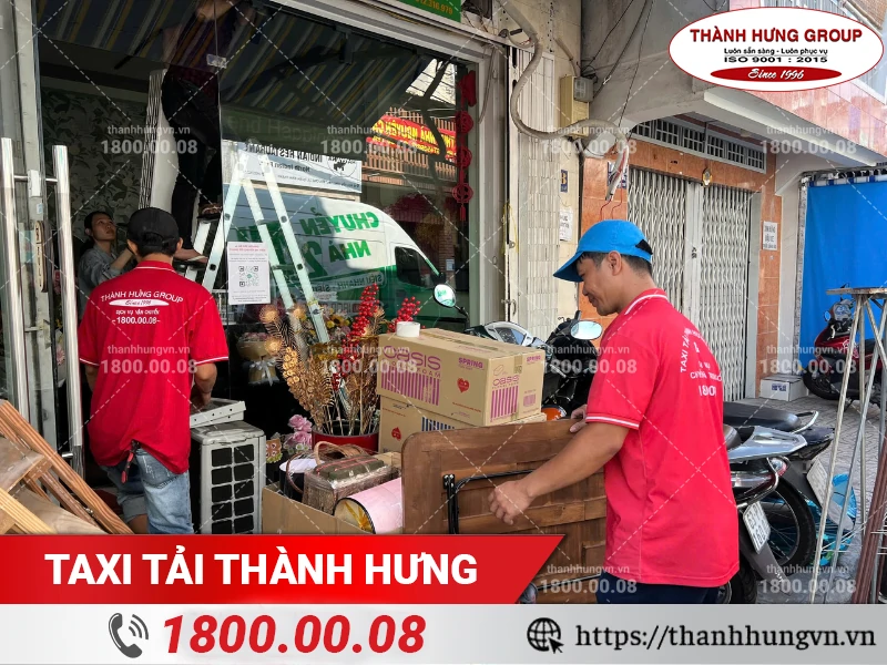 Nhân viên Thành Hưng bốc vác đồ đạc cửa hàng hoa ra ngoài