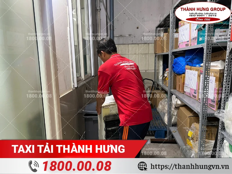 Nhân viên Thành Hưng khiêng máy lọc nước trong kho ra ngoài