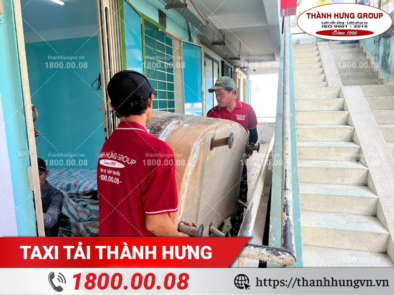 Nhân viên Thành Hưng khiêng ghế sofa ra ngoài cửa