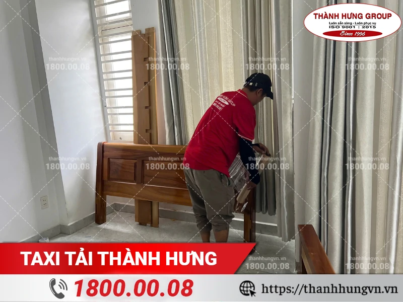 Nhân viên Thành Hưng dùng màng PE bọc lót đầu giường gỗ