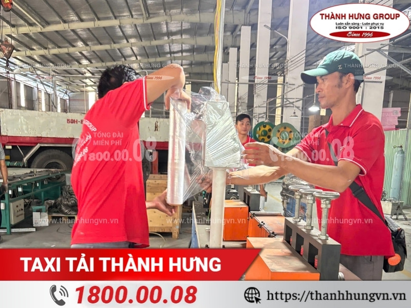 Nhân viên dùng màng PE quấn máy móc để tránh trầy xước khi vận chuyển